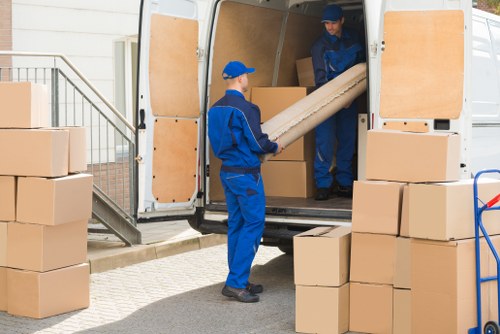 Professional movers packing items in Elmers End