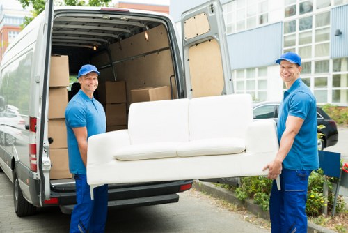 Professional movers handling a household item in Keston