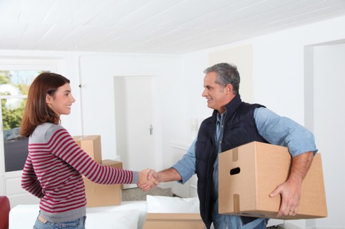 Movers carefully loading items for relocation.